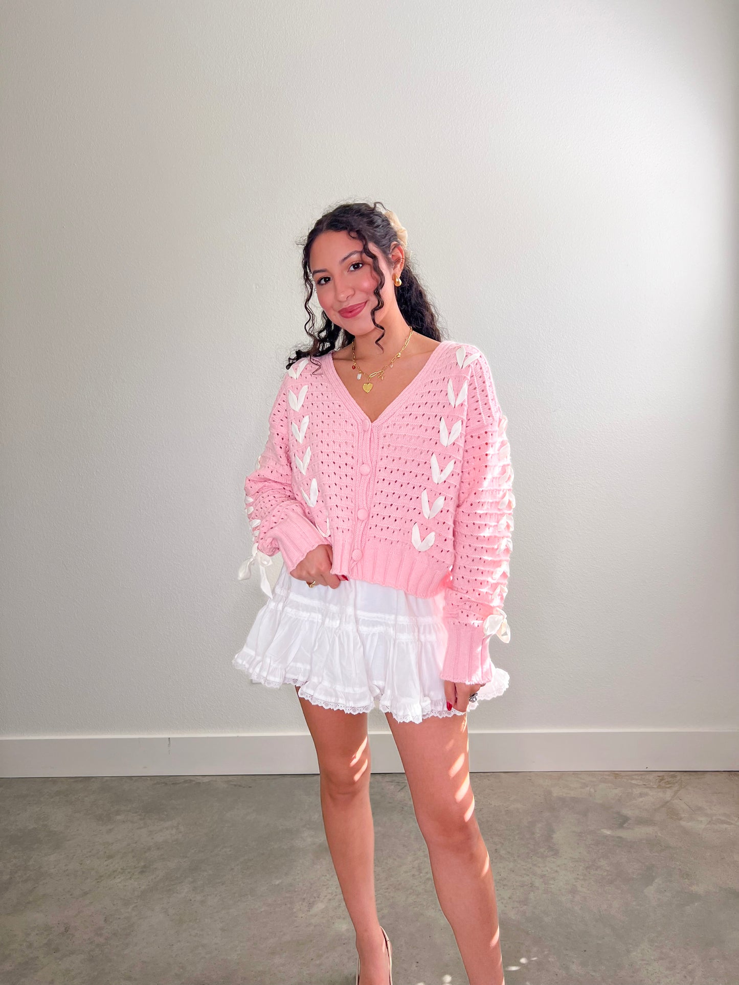 white skirt, white skort, white mini skort, white lace mini skort, pink and white cardigan, pink and white bow cardigan, pink and white bow sweater,